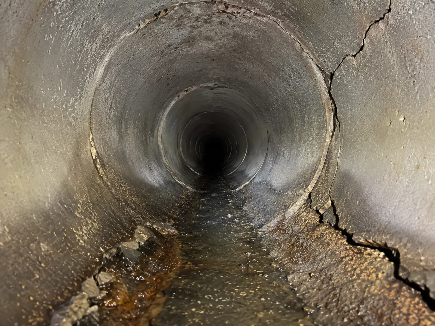Sewer camera inspection showing the inside of a cracked San Diego drain line before pipe relining
